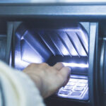 Closeup of a person using an ATM